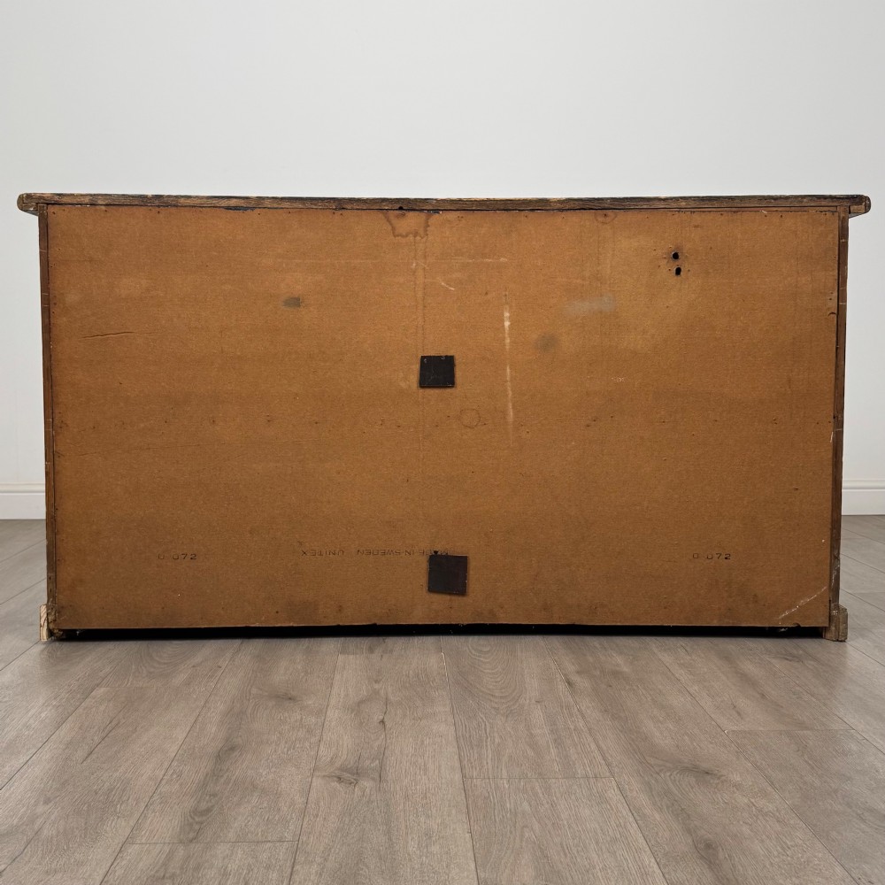 A 19th-century pine farmhouse dresser base featuring three upper drawers above two cupboard doors and an open central shelf. View VI