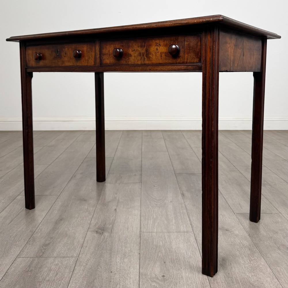 A dark mahogany Georgian style writing table featuring two frieze drawers with turned wood knobs and straight legs. View II