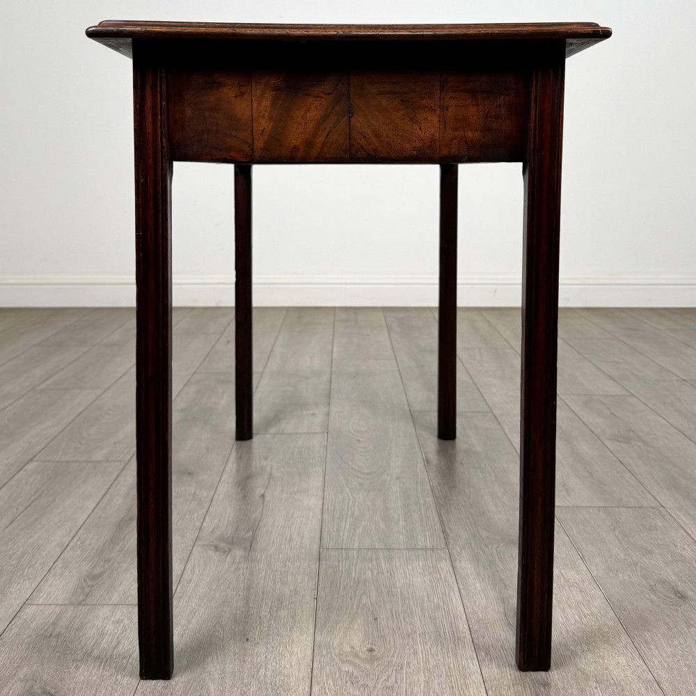A dark mahogany Georgian style writing table featuring two frieze drawers with turned wood knobs and straight legs. View III