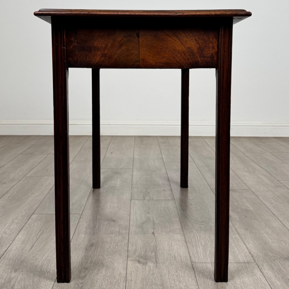 A dark mahogany Georgian style writing table featuring two frieze drawers with turned wood knobs and straight legs. View VII