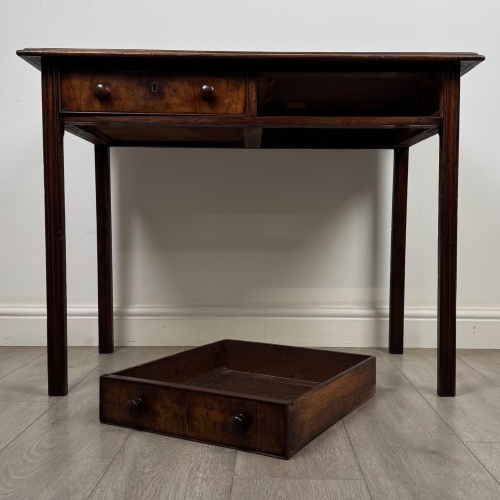 A dark mahogany Georgian style writing table featuring two frieze drawers with turned wood knobs and straight legs. View X