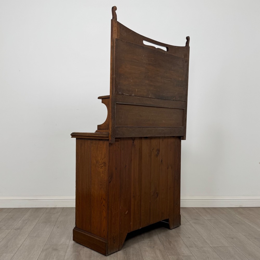 An early 20th-century warm brown oak mirror back sideboard featuring two drawers, a double-door cupboard base, and an elevated mirror plate cresting. View V