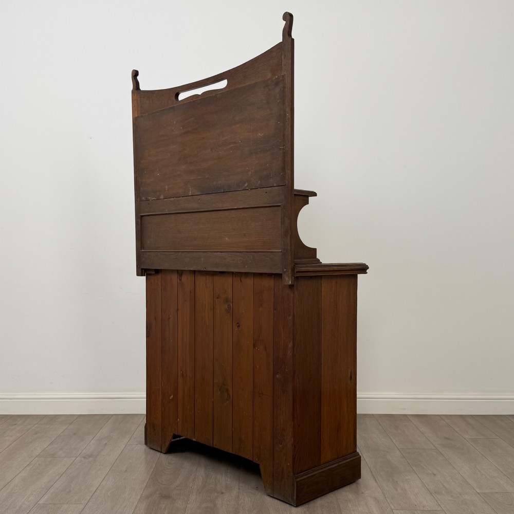 An early 20th-century warm brown oak mirror back sideboard featuring two drawers, a double-door cupboard base, and an elevated mirror plate cresting. View VII