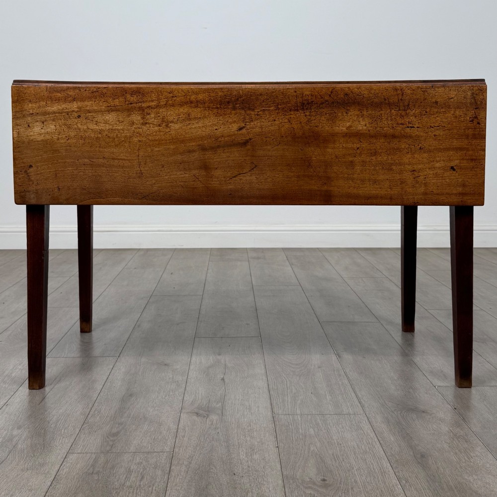 A 19th-century Georgian style dark mahogany Pembroke side table with drop leaves, tapered square legs, and a single frieze drawer with a brass drop handle. View VII