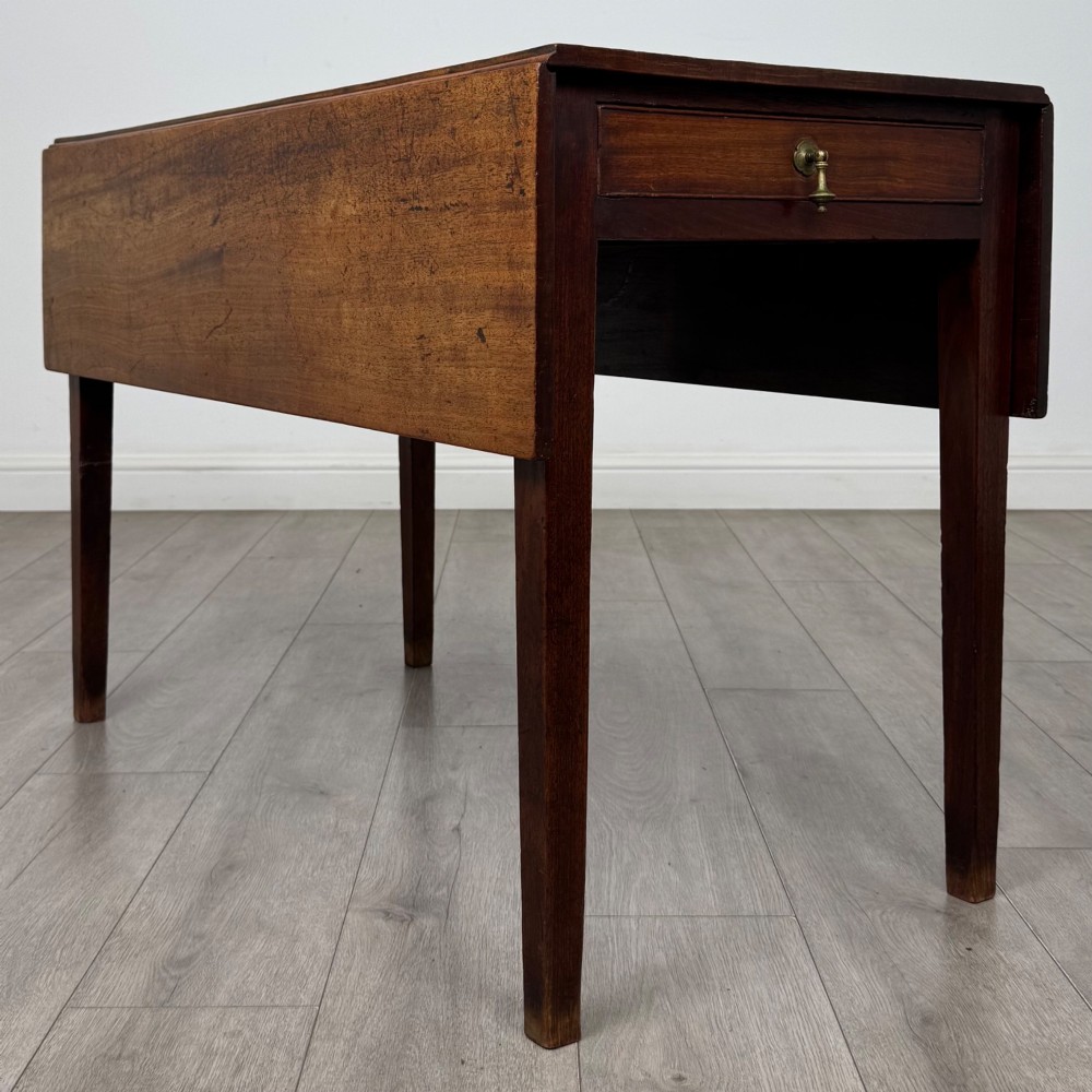 A 19th-century Georgian style dark mahogany Pembroke side table with drop leaves, tapered square legs, and a single frieze drawer with a brass drop handle. View VIII