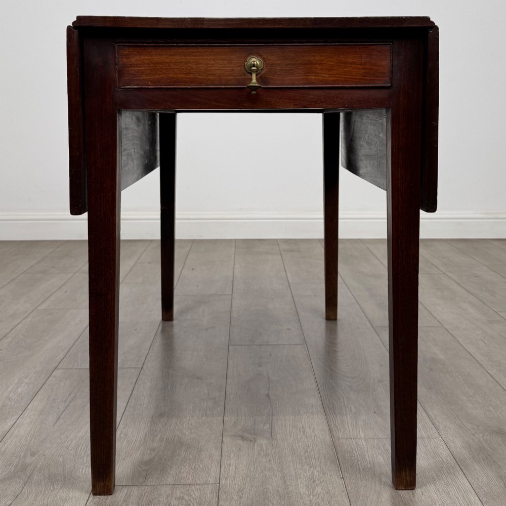 A 19th-century Georgian style dark mahogany Pembroke side table with drop leaves, tapered square legs, and a single frieze drawer with a brass drop handle. View IX