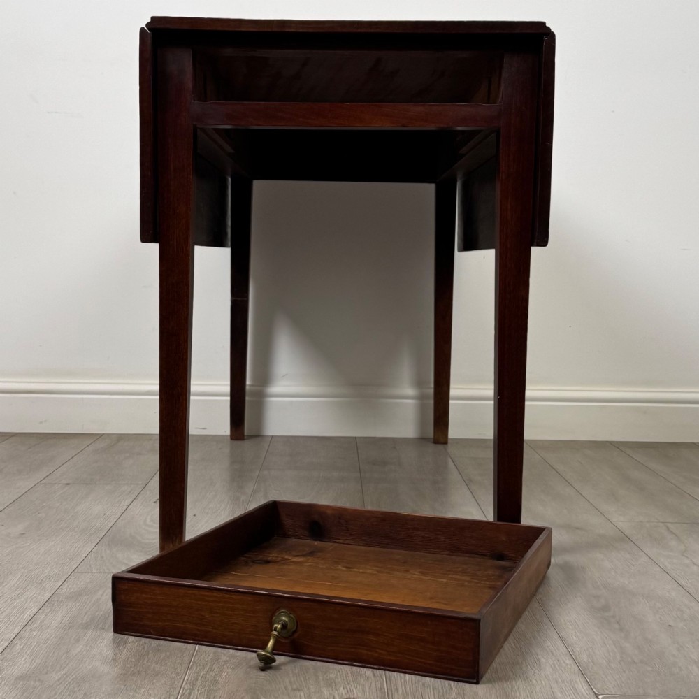 A 19th-century Georgian style dark mahogany Pembroke side table with drop leaves, tapered square legs, and a single frieze drawer with a brass drop handle. View XII