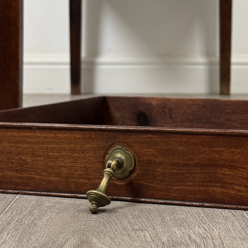 A 19th-century Georgian style dark mahogany Pembroke side table with drop leaves, tapered square legs, and a single frieze drawer with a brass drop handle. View XIII