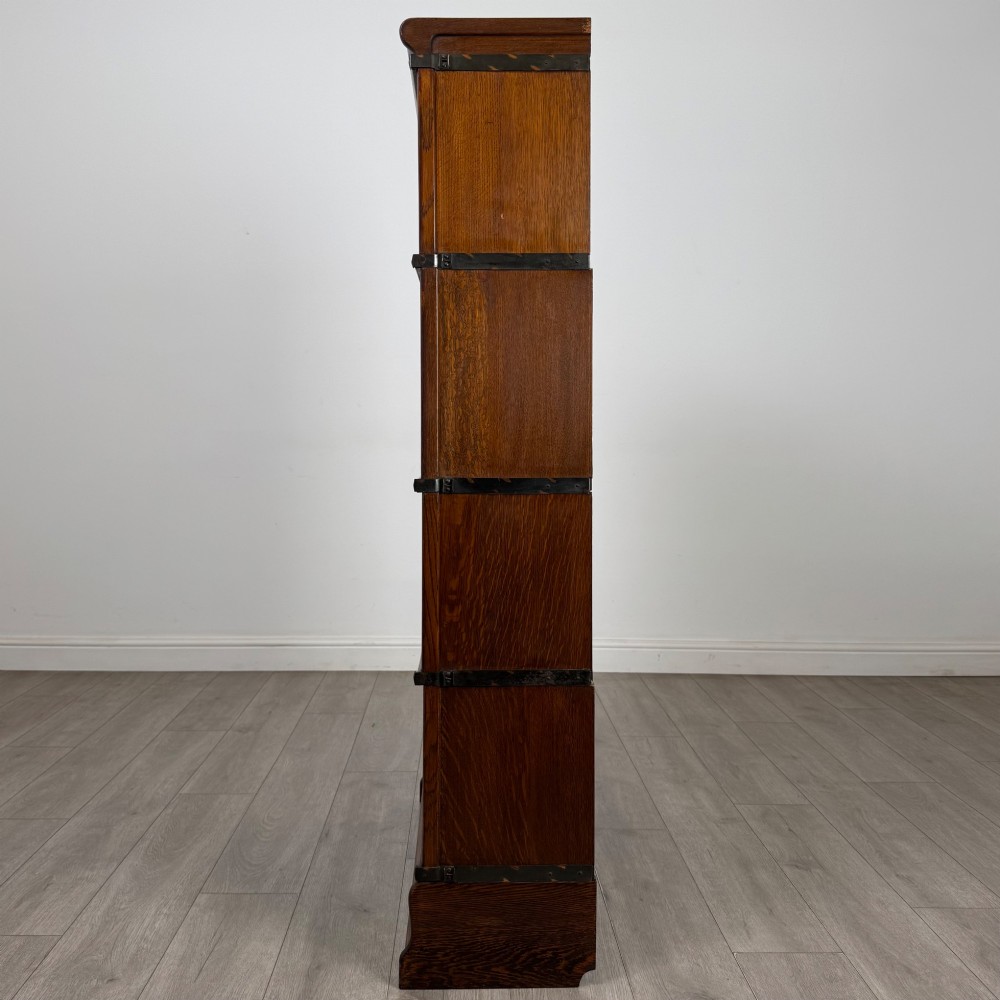 An early twentieth-century oak four-tier Globe Wernicke stacking bookcase featuring glazed lift-and-slide doors. View IV