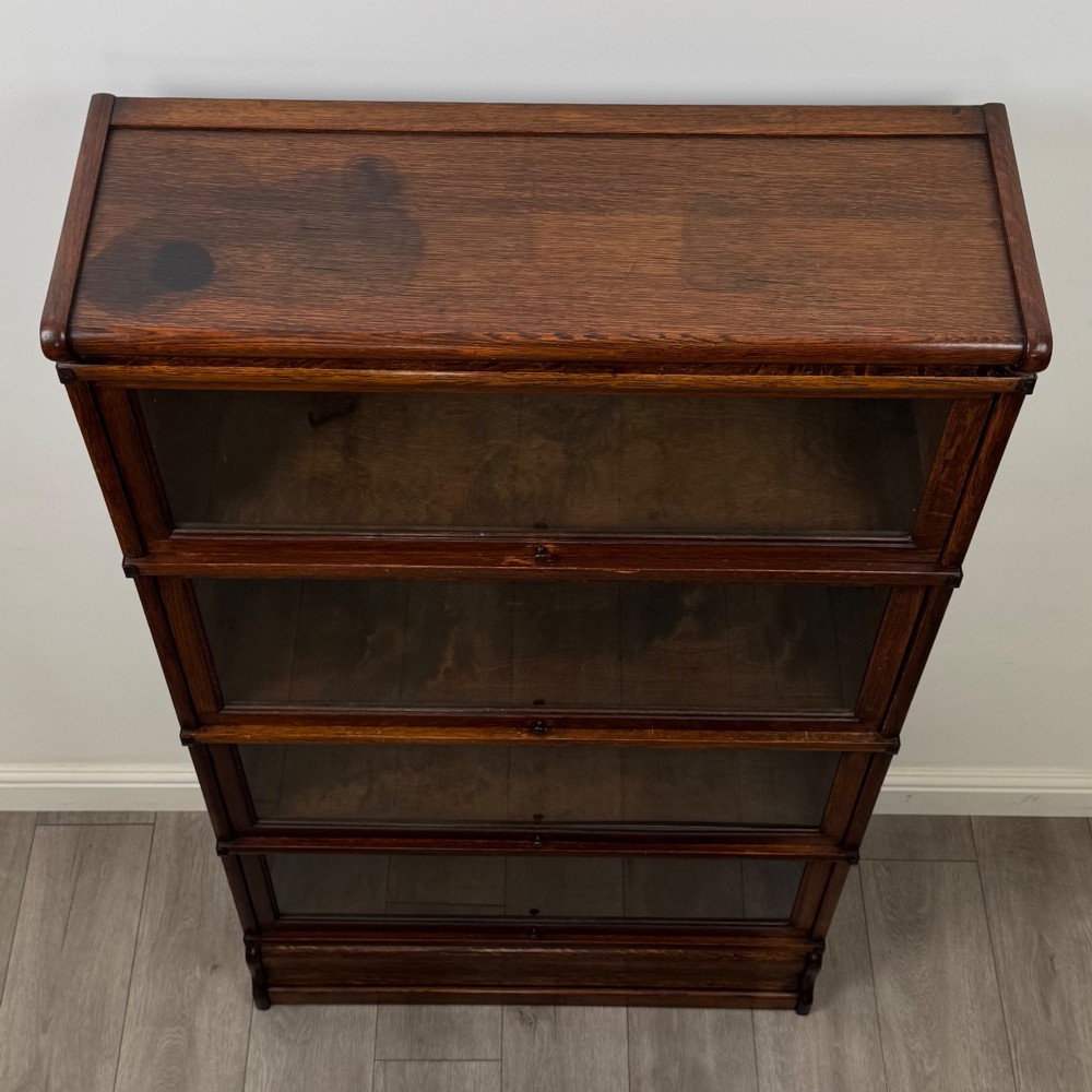An early twentieth-century oak four-tier Globe Wernicke stacking bookcase featuring glazed lift-and-slide doors. View X
