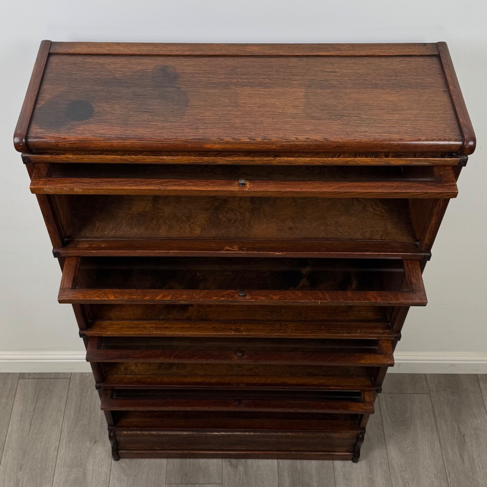 An early twentieth-century oak four-tier Globe Wernicke stacking bookcase featuring glazed lift-and-slide doors. View XI