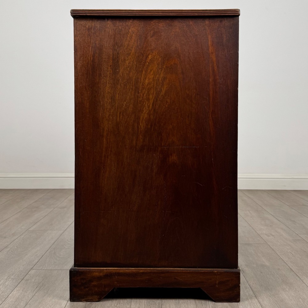 An eighteenth-century Georgian mahogany chest of drawers featuring two short upper drawers above two long lower drawers with oval brass handles. View III