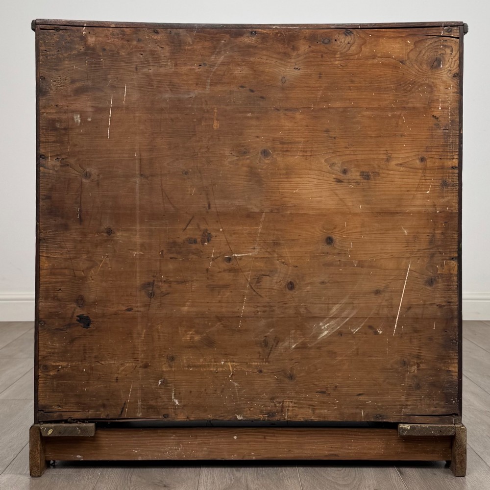 An eighteenth-century Georgian mahogany chest of drawers featuring two short upper drawers above two long lower drawers with oval brass handles. View V