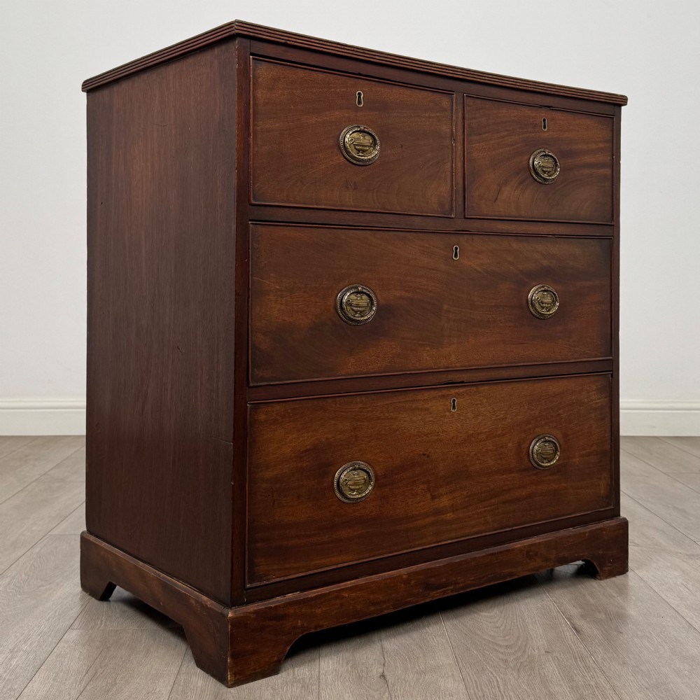 An eighteenth-century Georgian mahogany chest of drawers featuring two short upper drawers above two long lower drawers with oval brass handles. View VIII