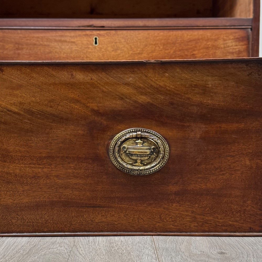 An eighteenth-century Georgian mahogany chest of drawers featuring two short upper drawers above two long lower drawers with oval brass handles. View XI