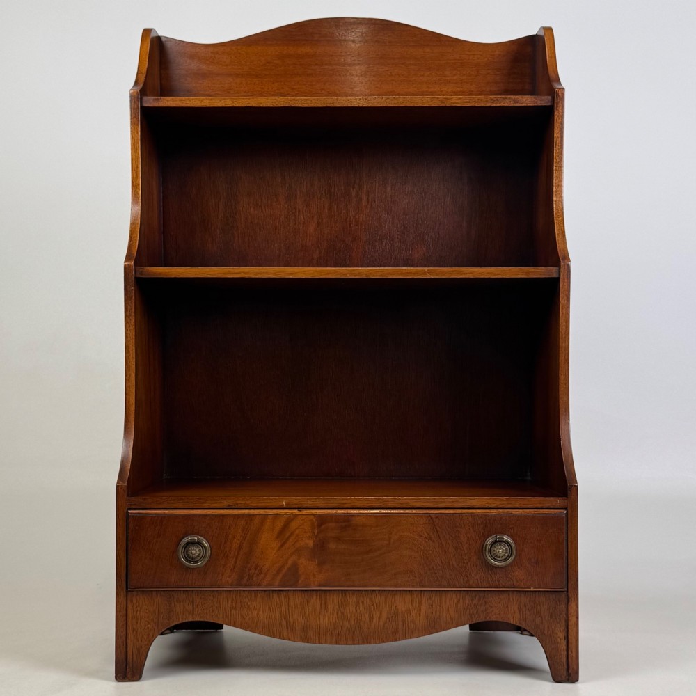 A small 20th-century mahogany open bookcase with a shaped top gallery, two open shelves, and a single lower drawer fitted with brass ring handles. View II