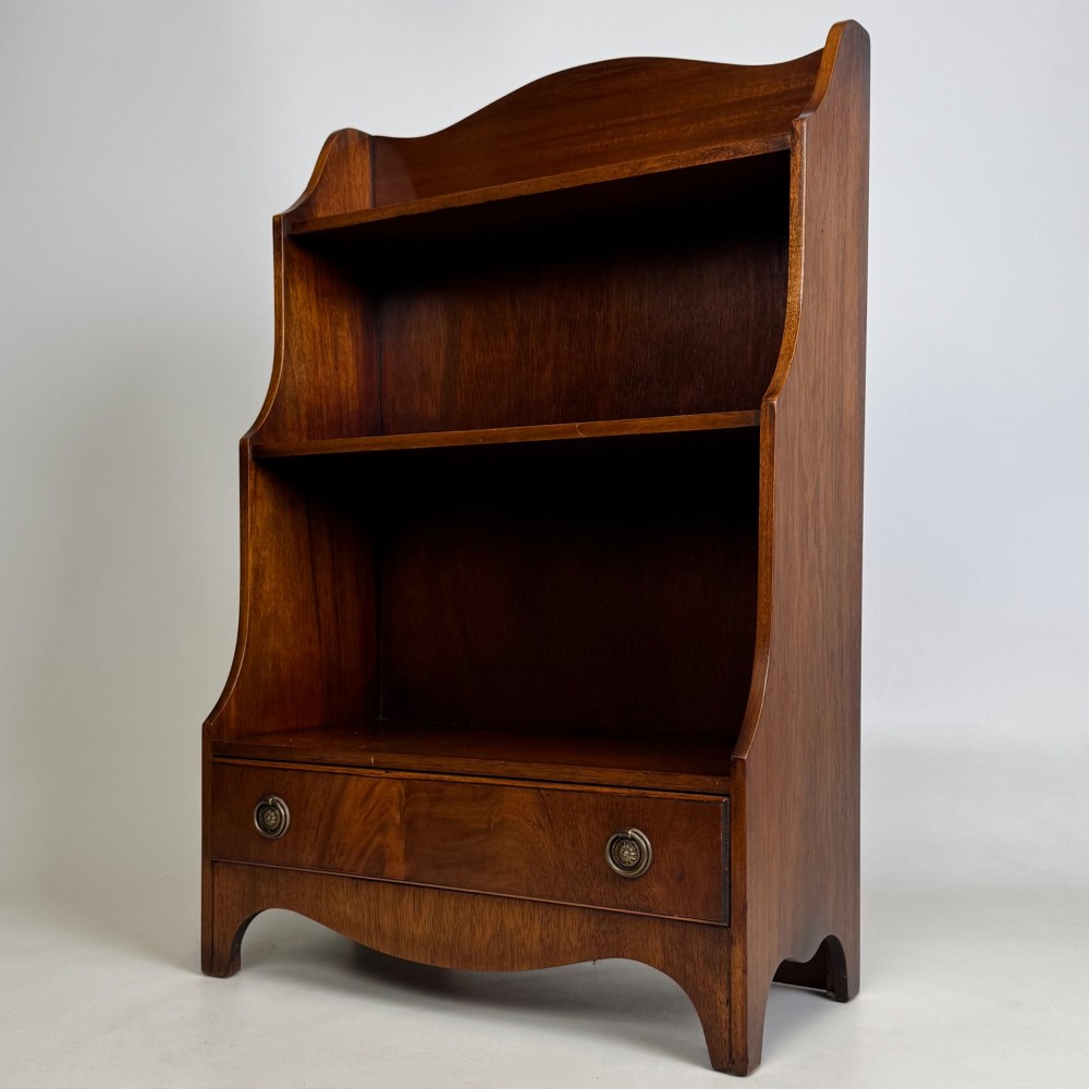 A small 20th-century mahogany open bookcase with a shaped top gallery, two open shelves, and a single lower drawer fitted with brass ring handles. View III
