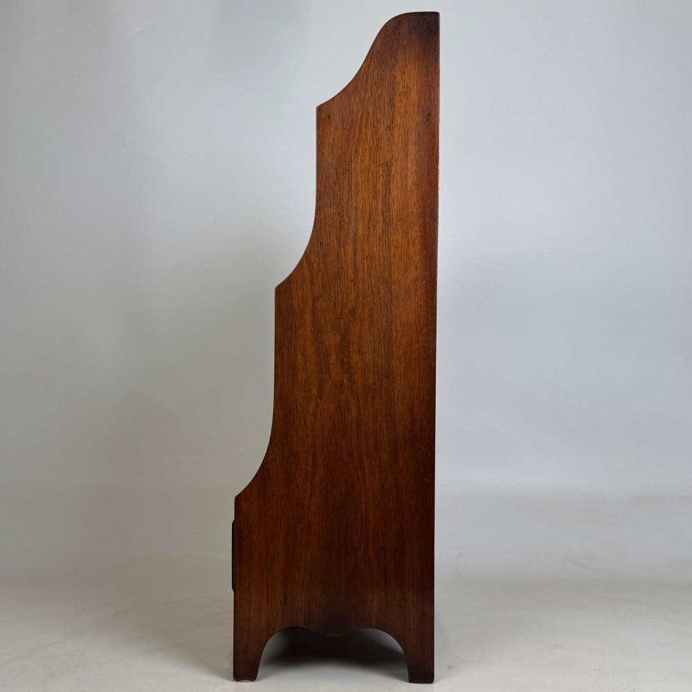 A small 20th-century mahogany open bookcase with a shaped top gallery, two open shelves, and a single lower drawer fitted with brass ring handles. View IV