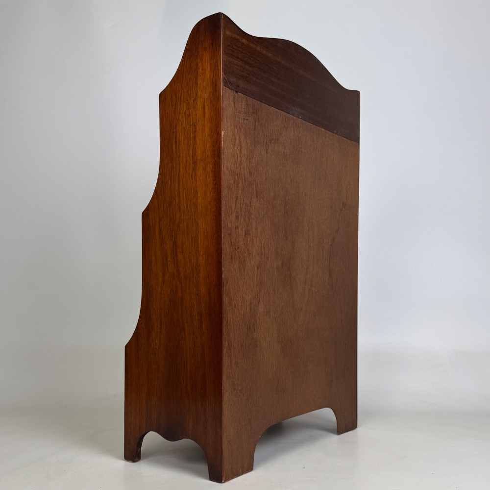 A small 20th-century mahogany open bookcase with a shaped top gallery, two open shelves, and a single lower drawer fitted with brass ring handles. View V