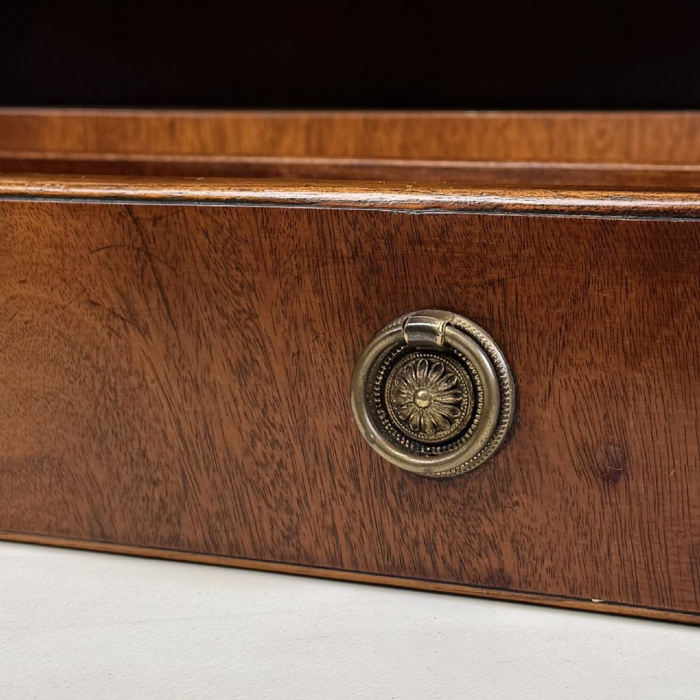 A small 20th-century mahogany open bookcase with a shaped top gallery, two open shelves, and a single lower drawer fitted with brass ring handles. View XI