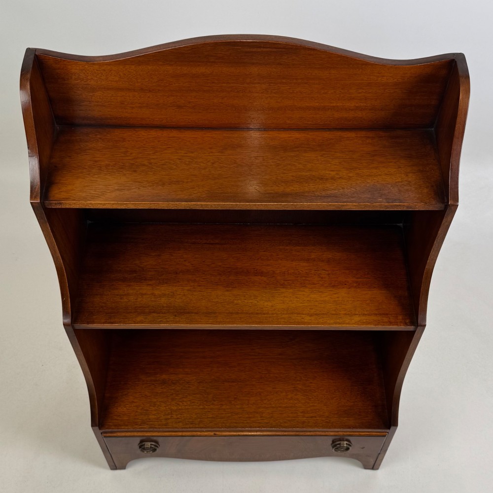 A small 20th-century mahogany open bookcase with a shaped top gallery, two open shelves, and a single lower drawer fitted with brass ring handles. View XII