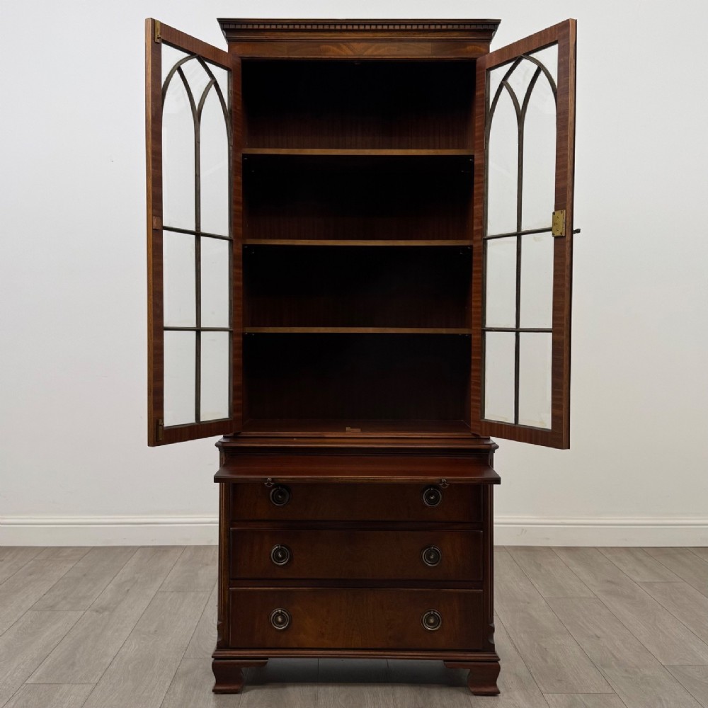 A tall Georgian style mahogany bookcase featuring two glazed doors with gothic arch tracery above a lower section with three drawers. View III