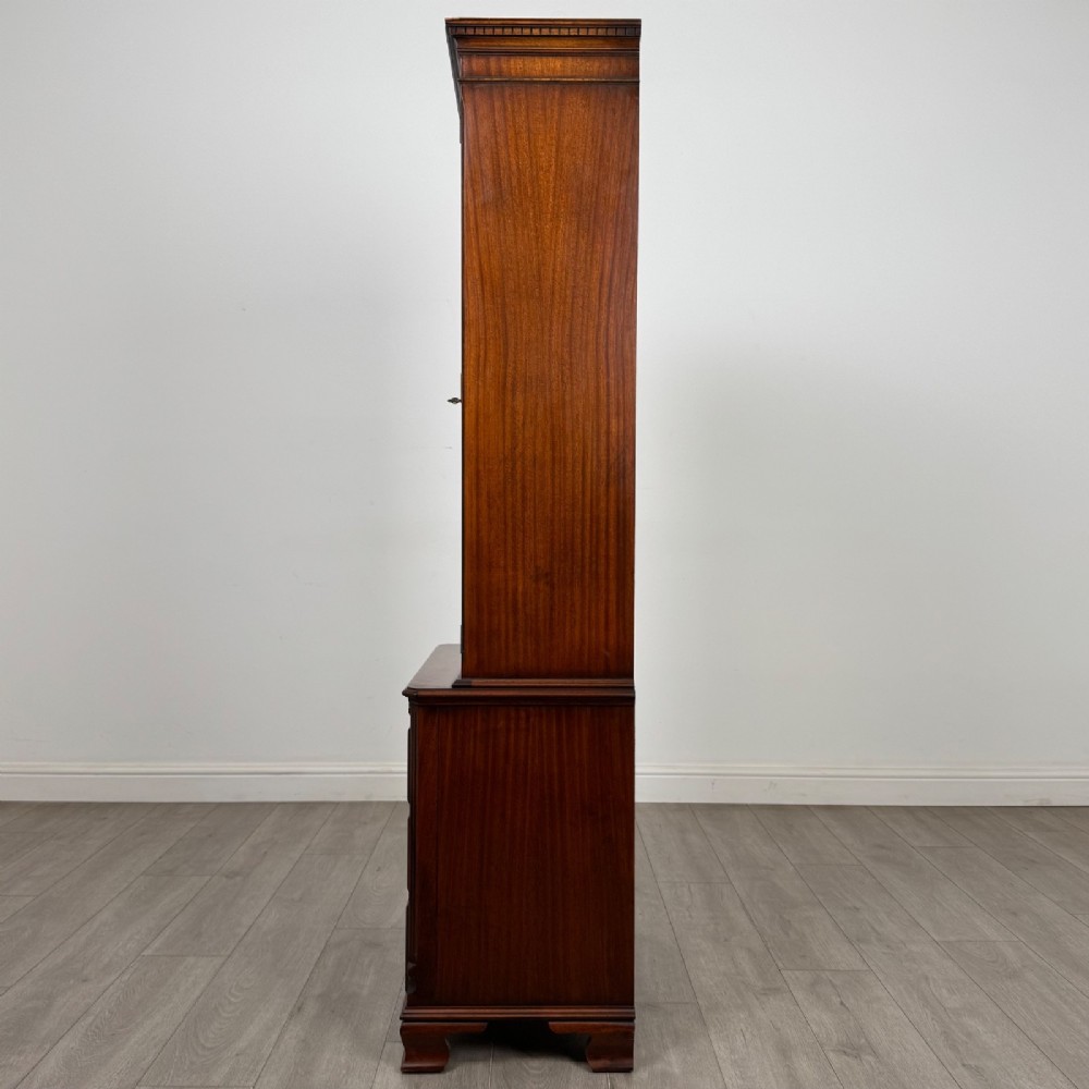 A tall Georgian style mahogany bookcase featuring two glazed doors with gothic arch tracery above a lower section with three drawers. View V
