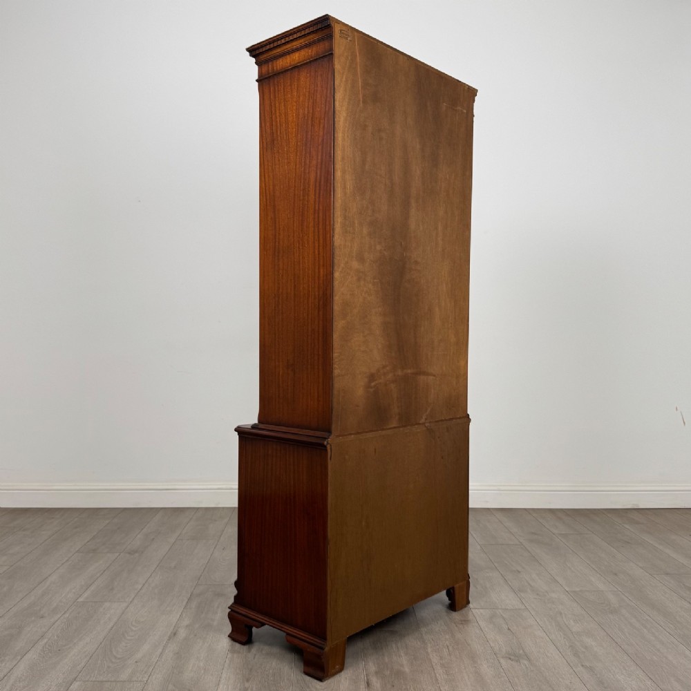 A tall Georgian style mahogany bookcase featuring two glazed doors with gothic arch tracery above a lower section with three drawers. View VI