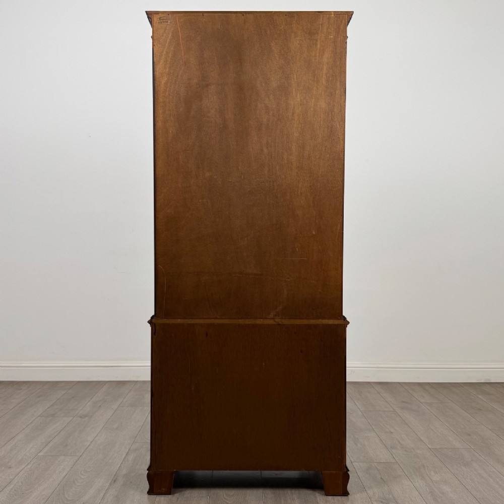 A tall Georgian style mahogany bookcase featuring two glazed doors with gothic arch tracery above a lower section with three drawers. View VII