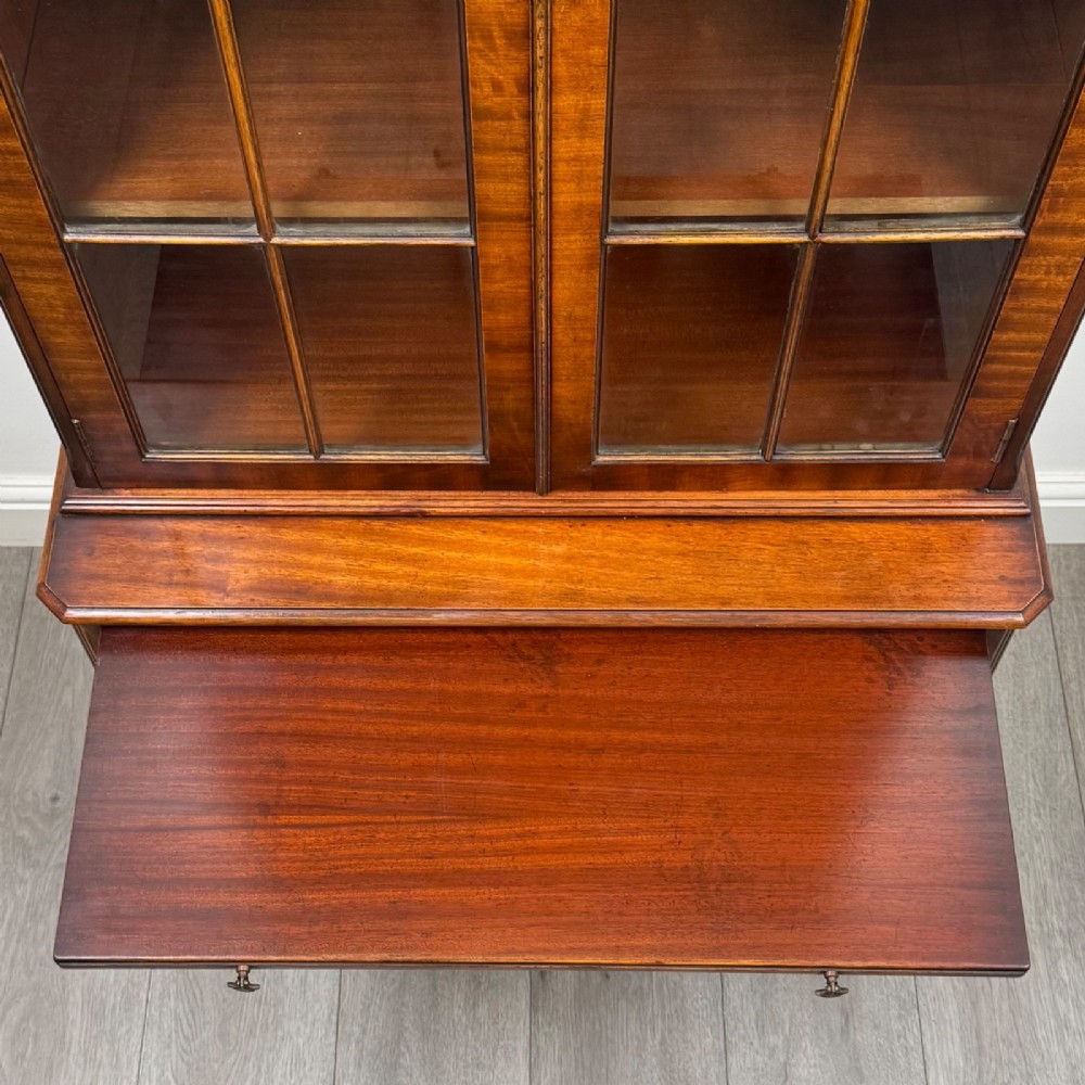 A tall Georgian style mahogany bookcase featuring two glazed doors with gothic arch tracery above a lower section with three drawers. View XII