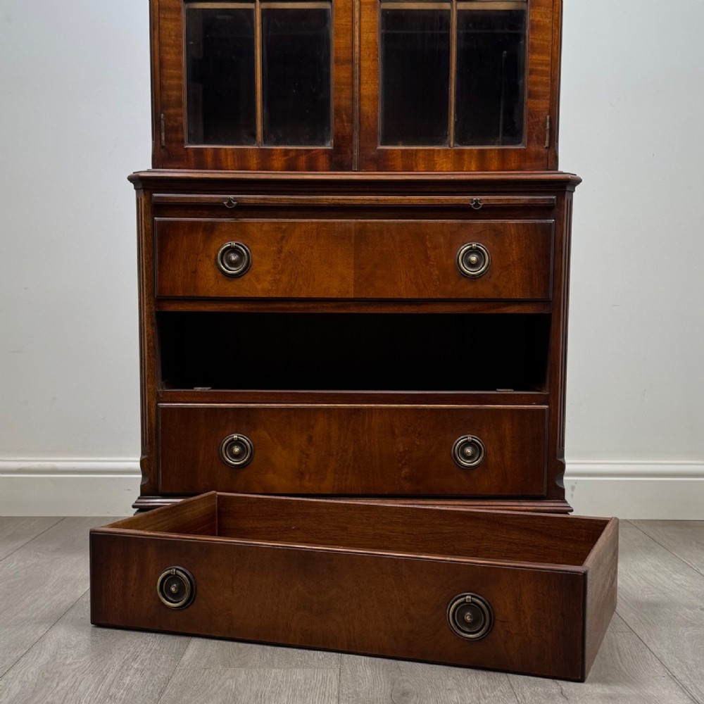 A tall Georgian style mahogany bookcase featuring two glazed doors with gothic arch tracery above a lower section with three drawers. View XIII