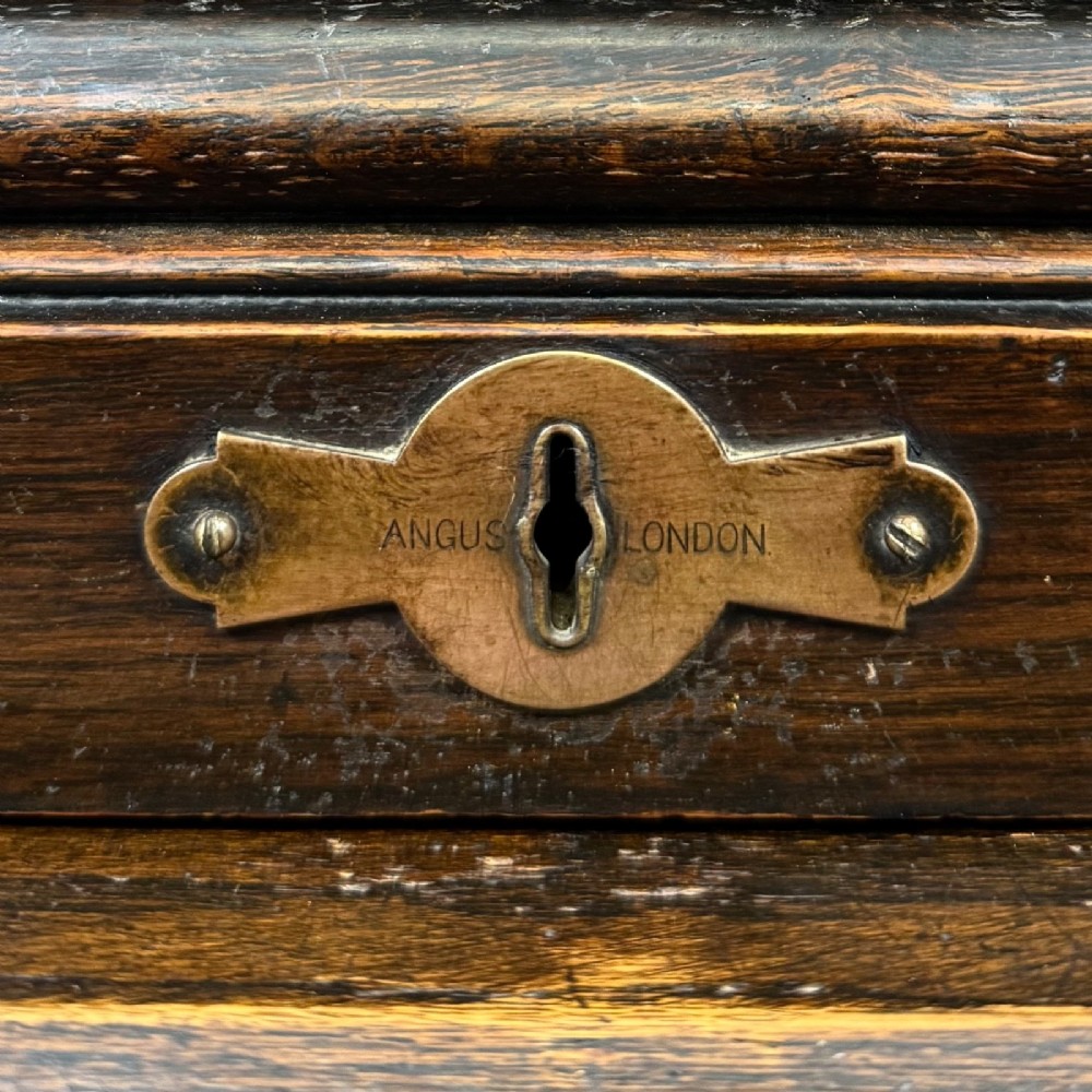 An Edwardian dark oak roll top desk featuring a slatted tambour front above a twin pedestal base with eight drawers. View XIV