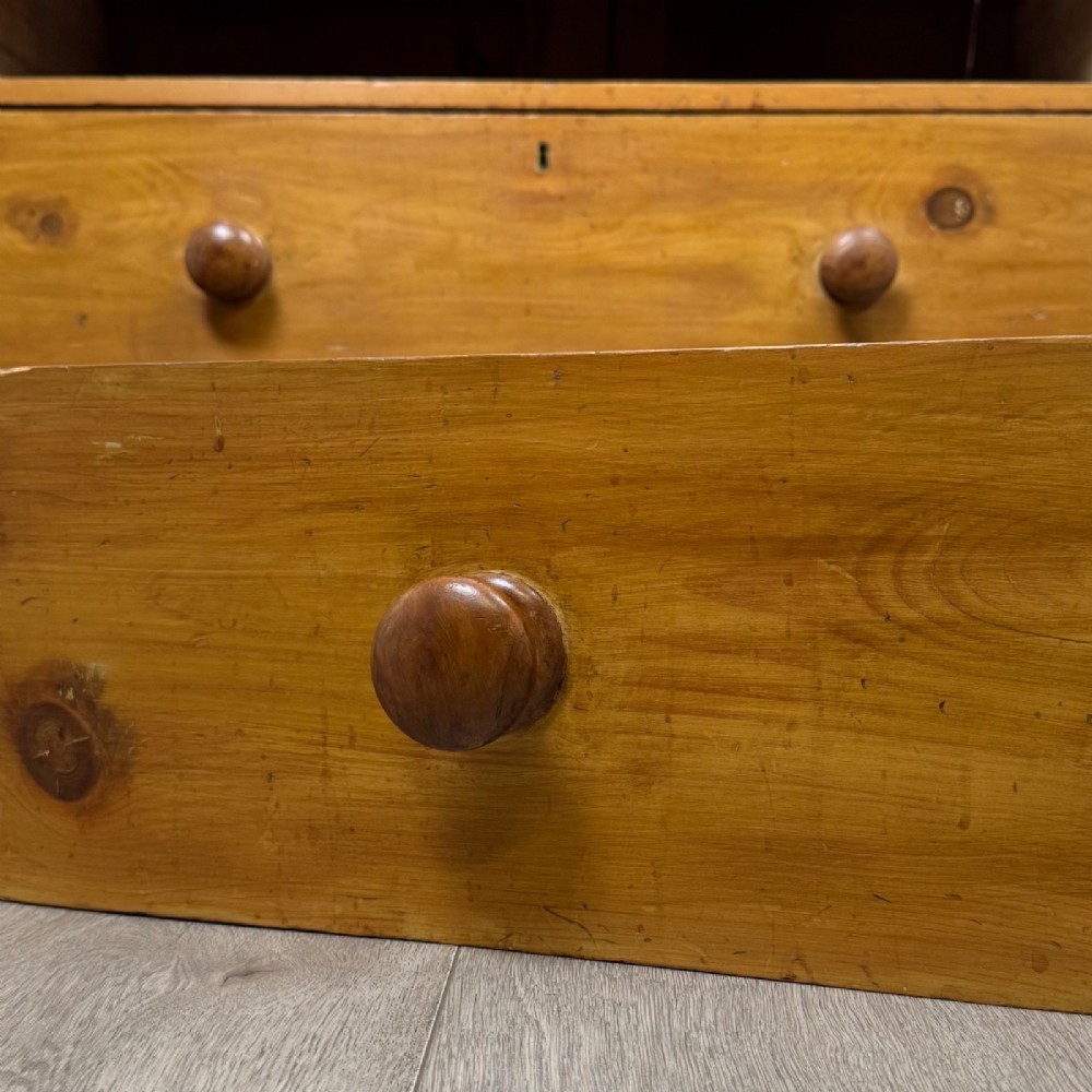 A Victorian pine chest of drawers featuring a two over two drawer layout, turned wooden knobs, and turned feet. View XI