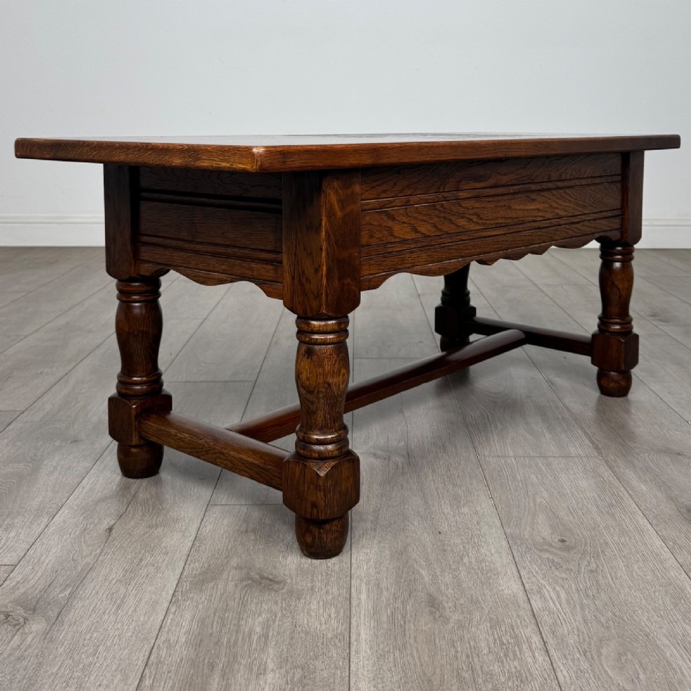A dark oak rectangular coffee table featuring two front drawers with wooden knob handles and turned baluster legs connected by a low stretcher. View IV