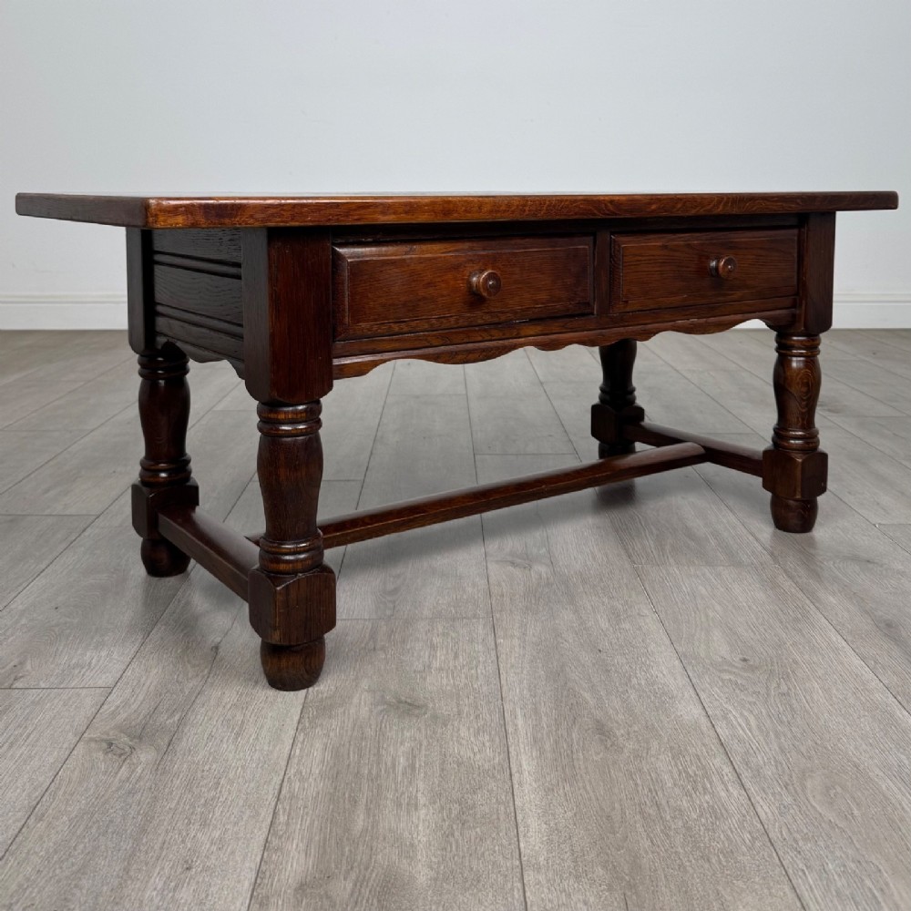A dark oak rectangular coffee table featuring two front drawers with wooden knob handles and turned baluster legs connected by a low stretcher. View VIII