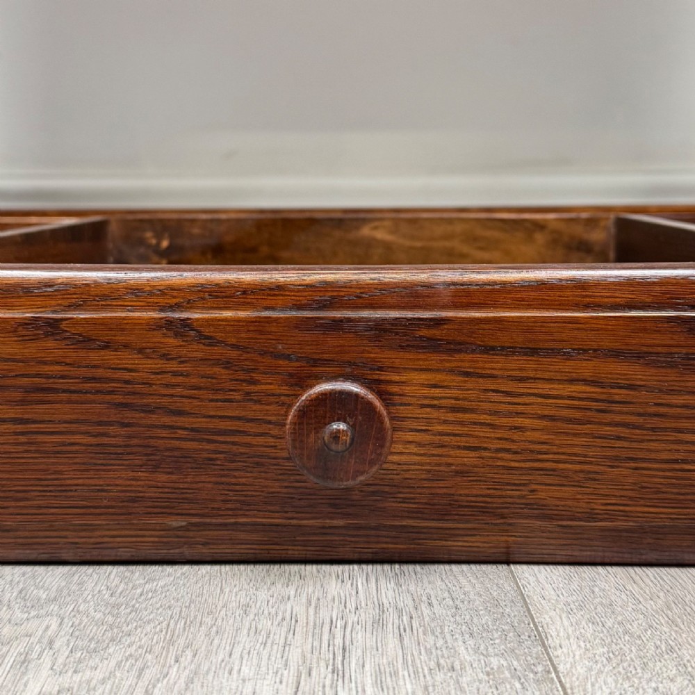 A dark oak rectangular coffee table featuring two front drawers with wooden knob handles and turned baluster legs connected by a low stretcher. View XI