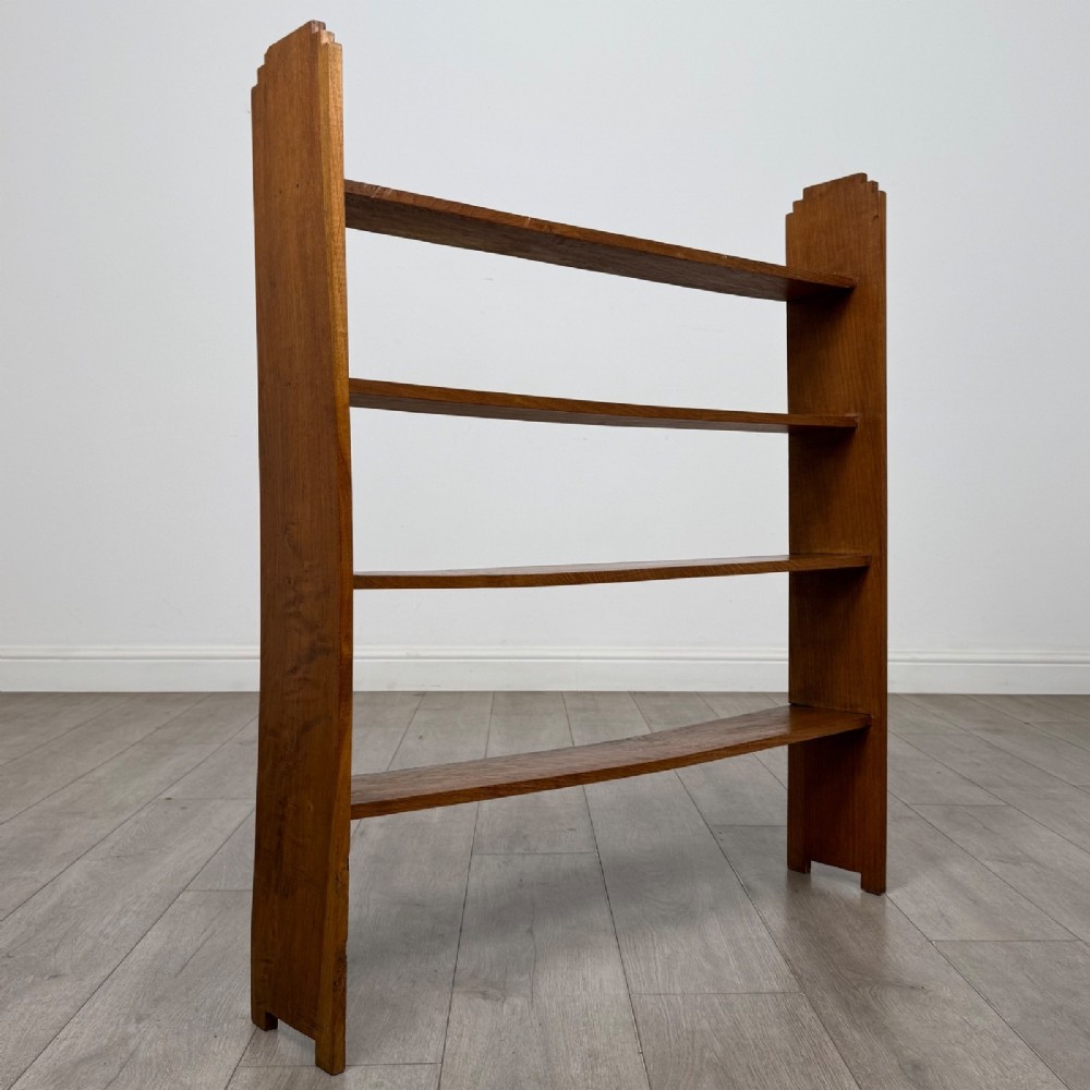 An open-backed 20th-century Arts and Crafts walnut bookcase with four horizontal shelves and notched top end supports. View VIII