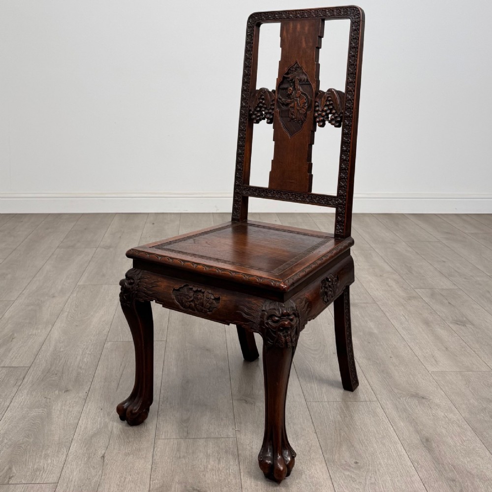 A set of six antique dark rosewood Chinese dining chairs featuring carved back splats, scroll armrests on carvers, carved aprons, and claw feet. View IV