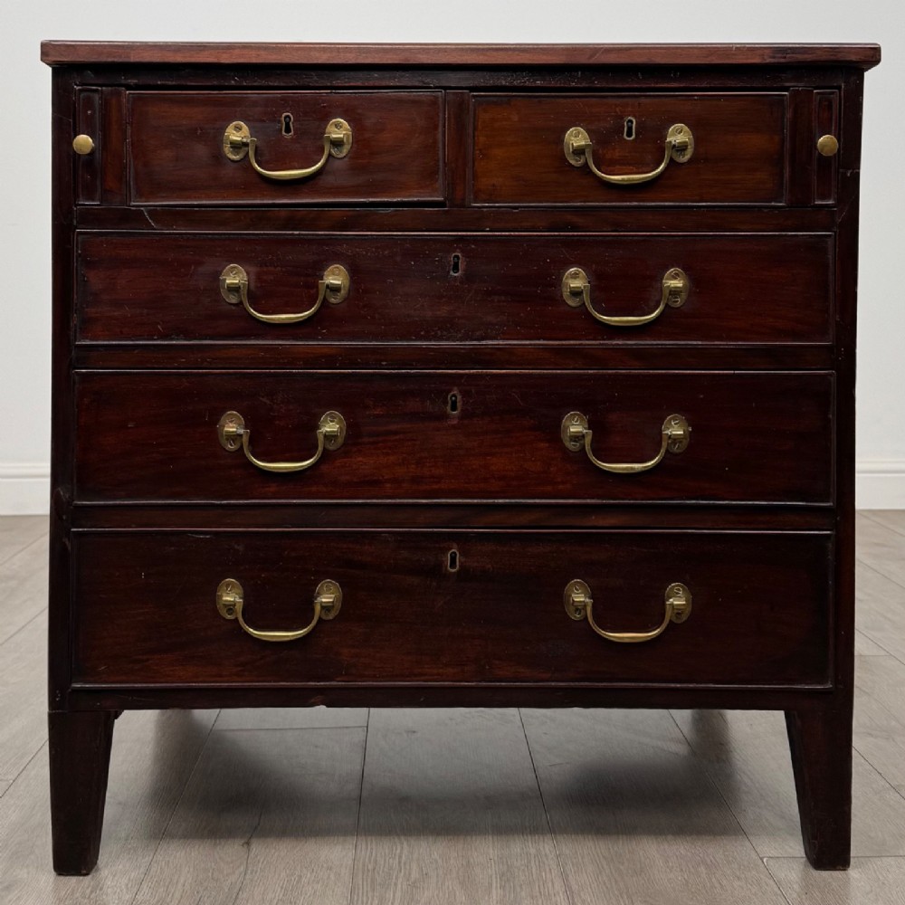 An 18th-century Georgian dark mahogany chest of drawers with two short drawers over three long drawers and brass swan-neck handles.