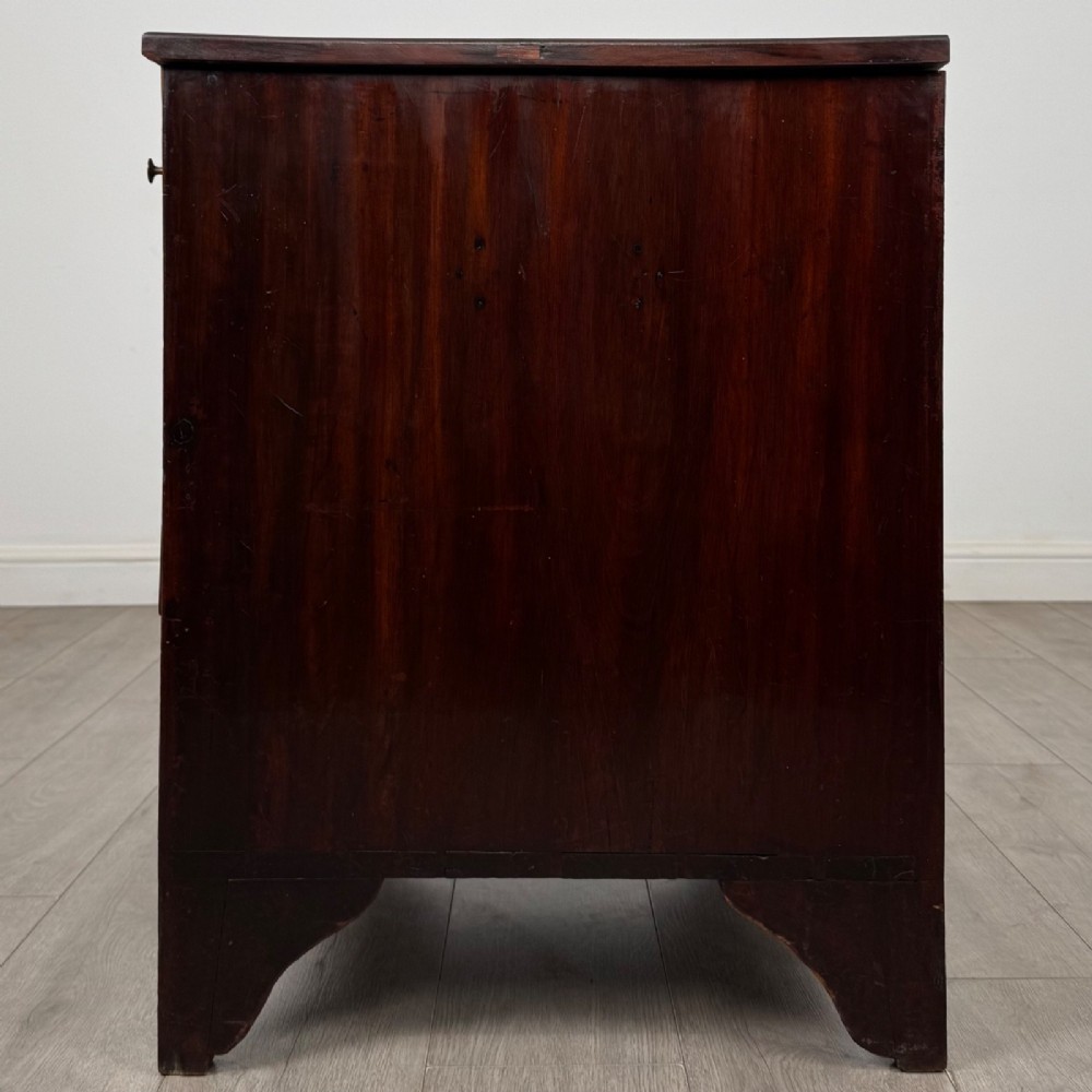 An 18th-century Georgian dark mahogany chest of drawers with two short drawers over three long drawers and brass swan-neck handles. View III