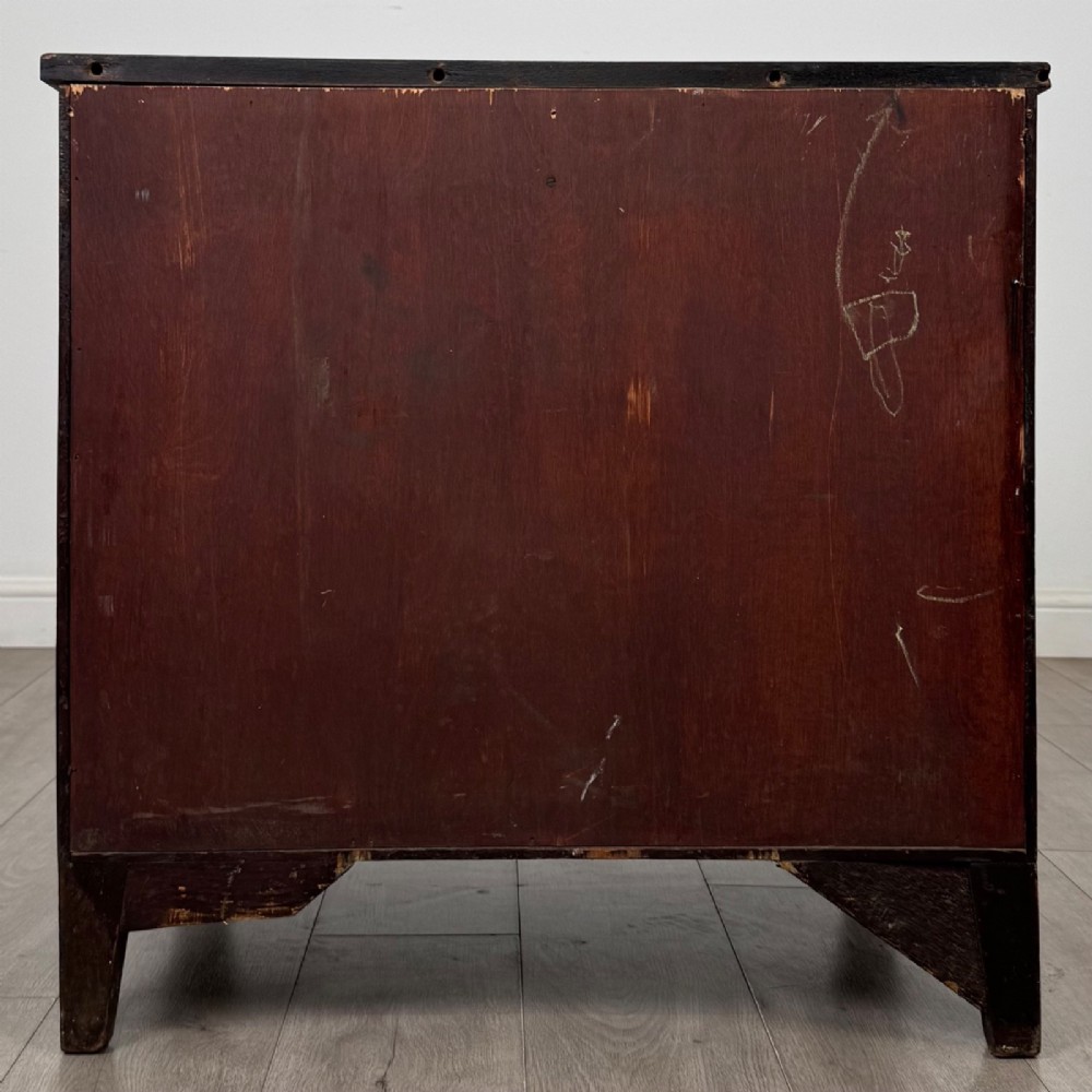 An 18th-century Georgian dark mahogany chest of drawers with two short drawers over three long drawers and brass swan-neck handles. View V