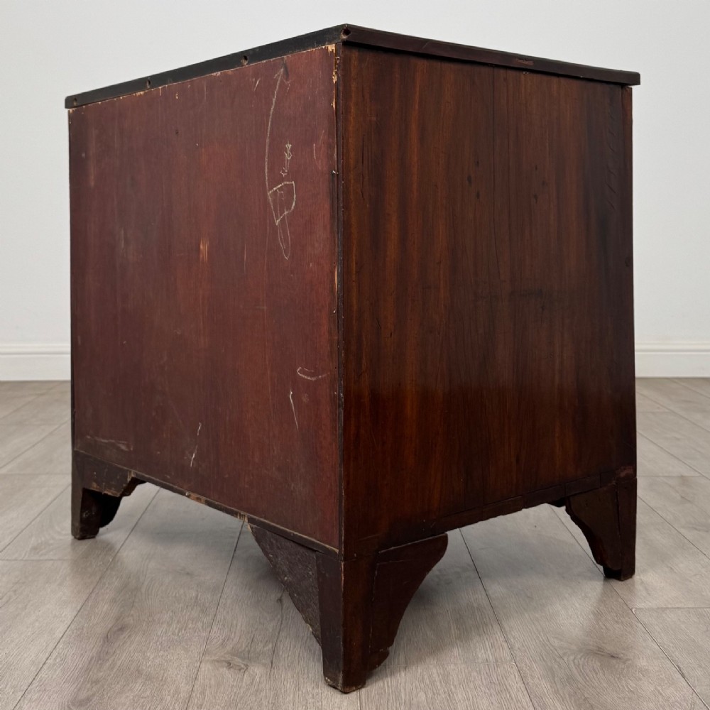 An 18th-century Georgian dark mahogany chest of drawers with two short drawers over three long drawers and brass swan-neck handles. View VI