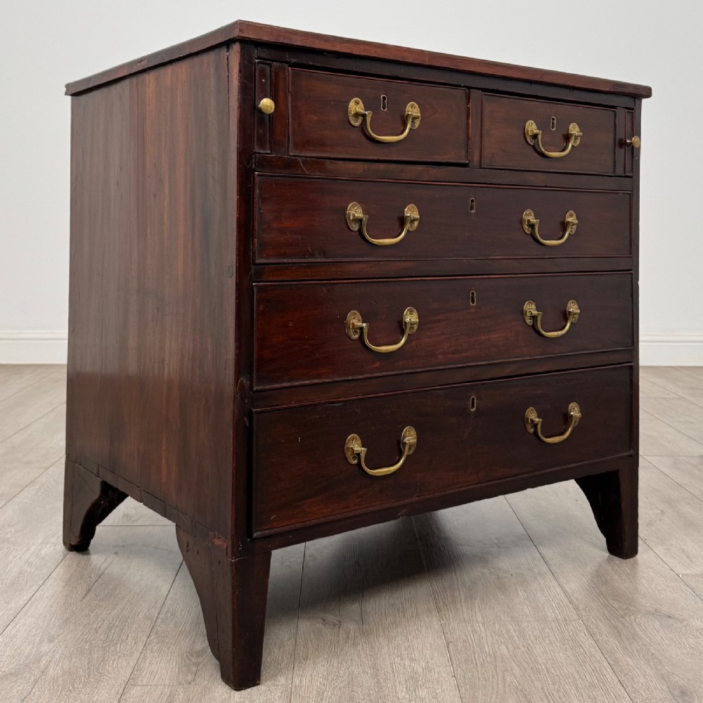 An 18th-century Georgian dark mahogany chest of drawers with two short drawers over three long drawers and brass swan-neck handles. View VIII