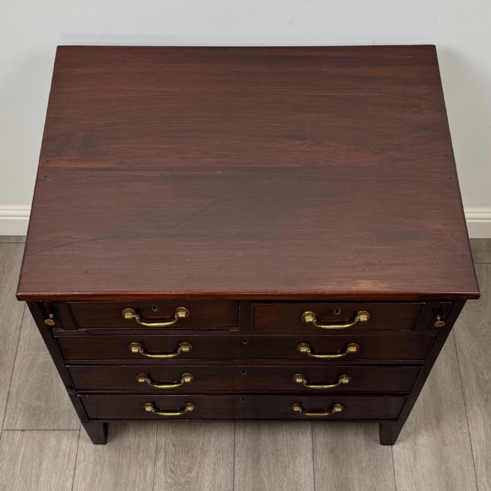 An 18th-century Georgian dark mahogany chest of drawers with two short drawers over three long drawers and brass swan-neck handles. View IX