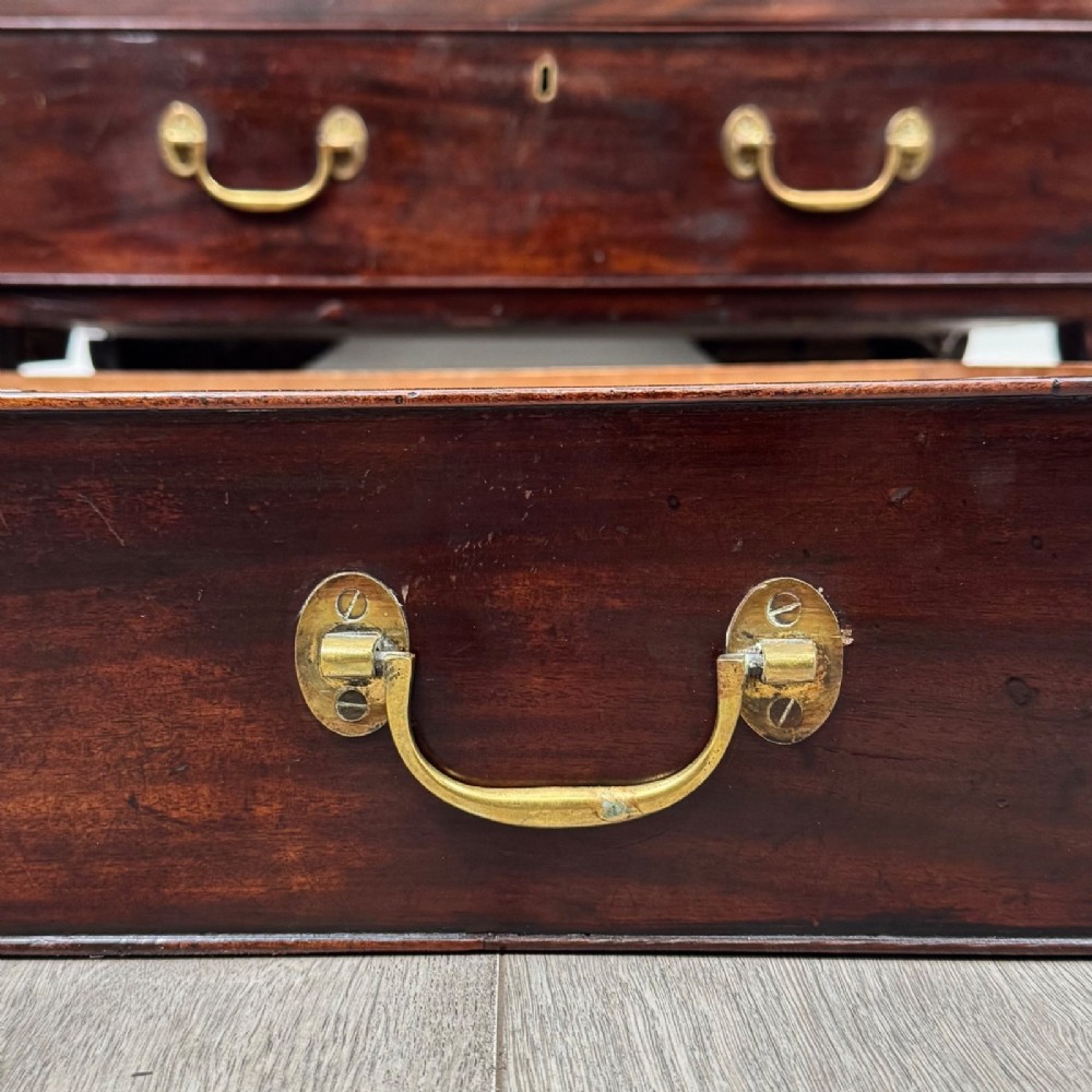 An 18th-century Georgian dark mahogany chest of drawers with two short drawers over three long drawers and brass swan-neck handles. View XI