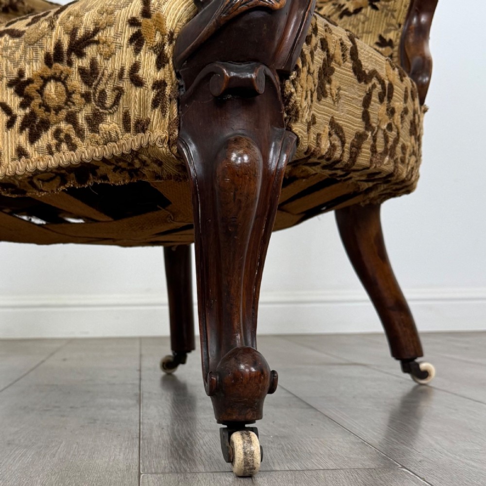 A 19th-century Victorian open armchair constructed from carved walnut wood and upholstered in a patterned gold and brown velvet fabric. View XI