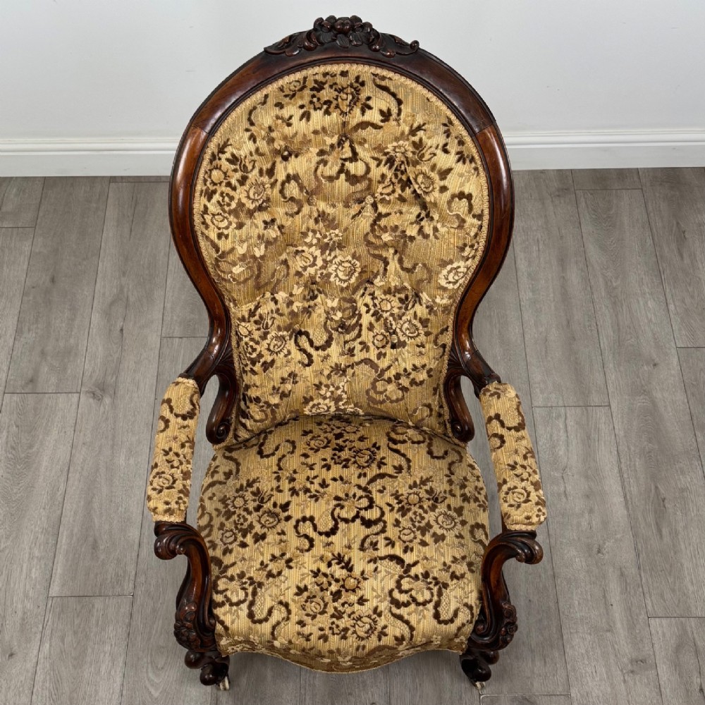 A 19th-century Victorian open armchair constructed from carved walnut wood and upholstered in a patterned gold and brown velvet fabric. View XIII
