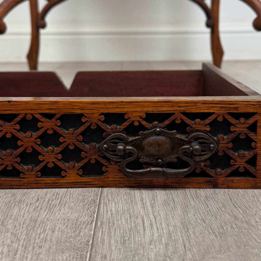 An Edwardian oak envelope card table featuring cabriole legs, a decorative carved drawer front, and a shaped lower shelf. View XII