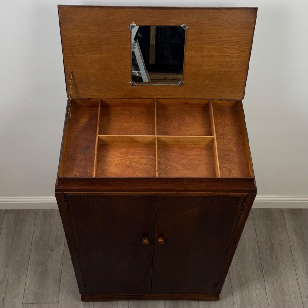 A compact 20th-century oak fitted wardrobe with two doors featuring diagonal grain veneering, turned wooden knobs, and a stepped top profile. View XI