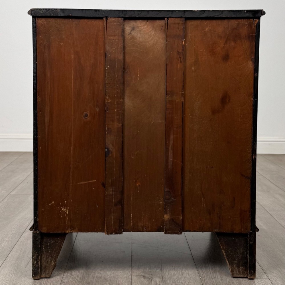 A nineteenth-century dark mahogany small cupboard featuring two drawers with brass swan-neck handles above a double-door compartment set on bracket feet. View VI